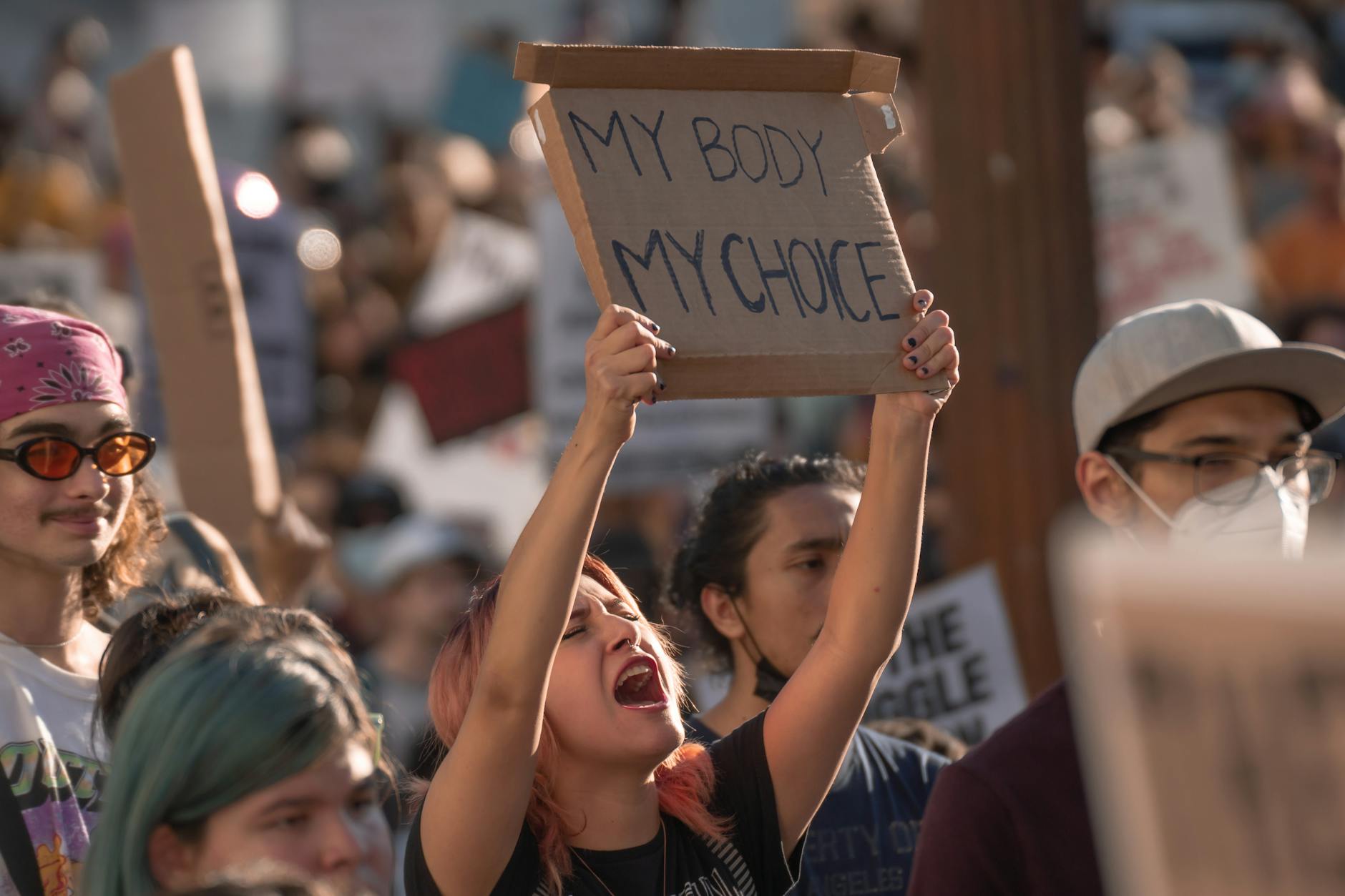 a woman protesting holding a banner