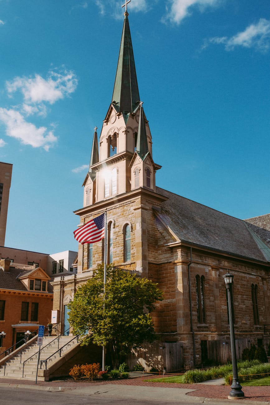 american flag in front of a church building