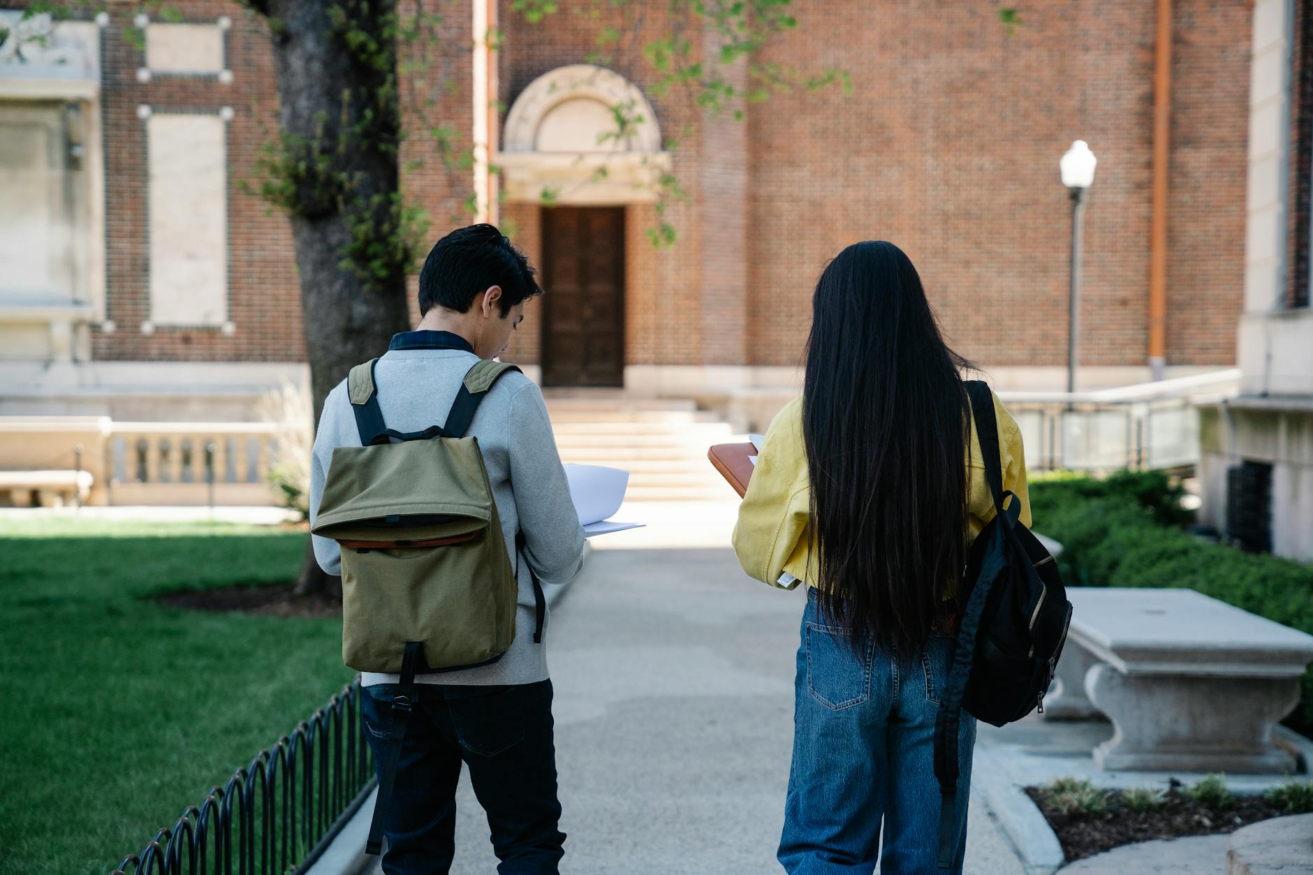 man and woman walking on pavement
